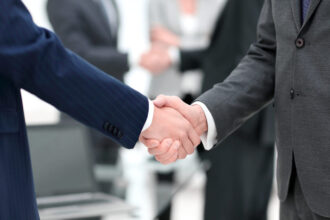 Two business brokers shaking eachother's hand