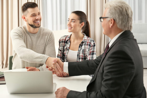 A Californian public adjuster shaking hands with a young couple.